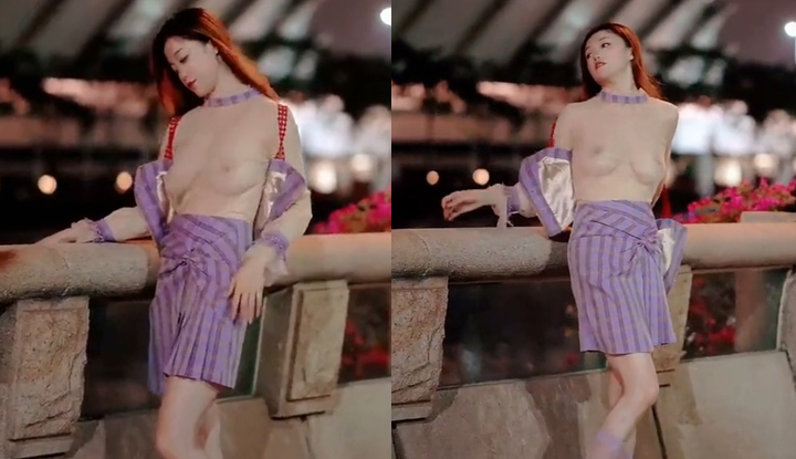 Goddes yang kontras dengan skala besar, menunjukkan payudara besar yang seksi dan menawan dengan kain tipis di tepi sungai.