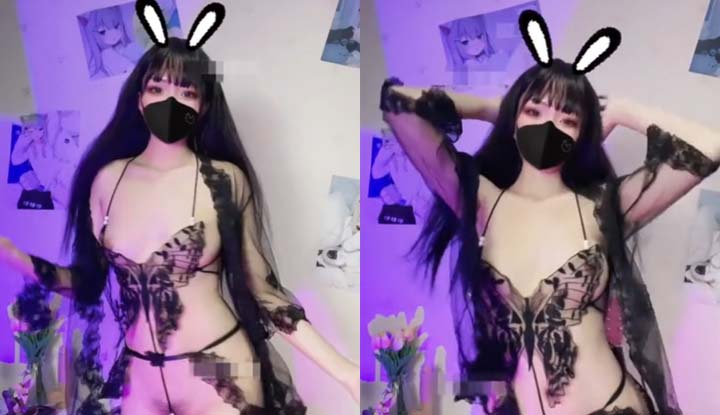 The playful bunny wearing sexy lingerie is dancing seductively, her perky breasts almost popping out.